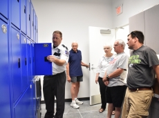 During a tour of the city’s new public safety building July 7, Lake City Police Chief Cory Kubista demonstrates that pass-through locker system that will allow the police department to store evidence more securely and efficiently.